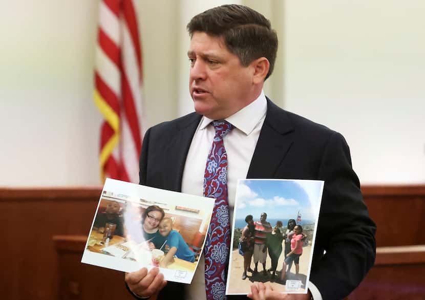 Assistant Tarrant County Criminal District Attorney Dale Smith holds photographs of Atatiana...