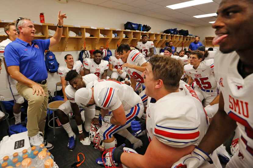 SMU head coach Sonny Dykes talks with his team in the locker room right before opening...