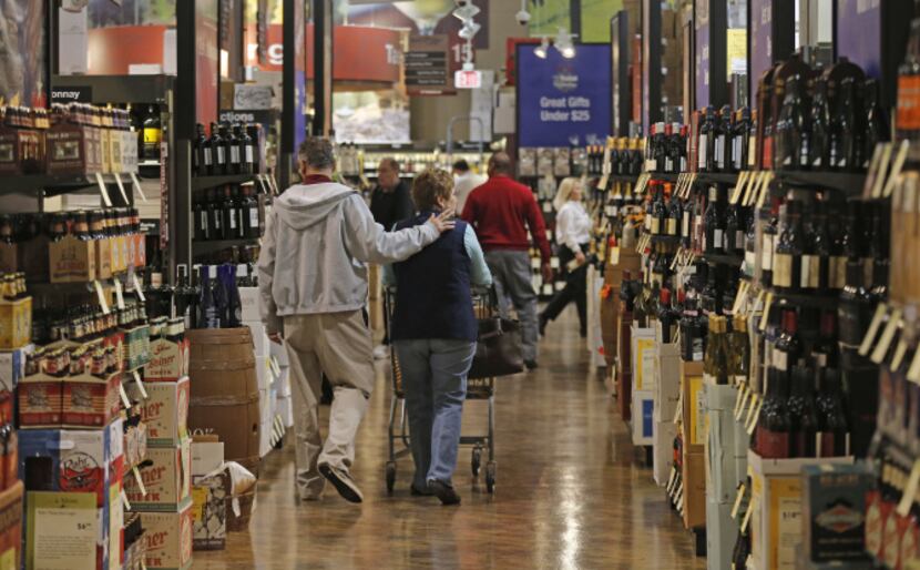 Ernie Serrano and his wife, Toni, shop at the Total Wine & More store in Plano.
