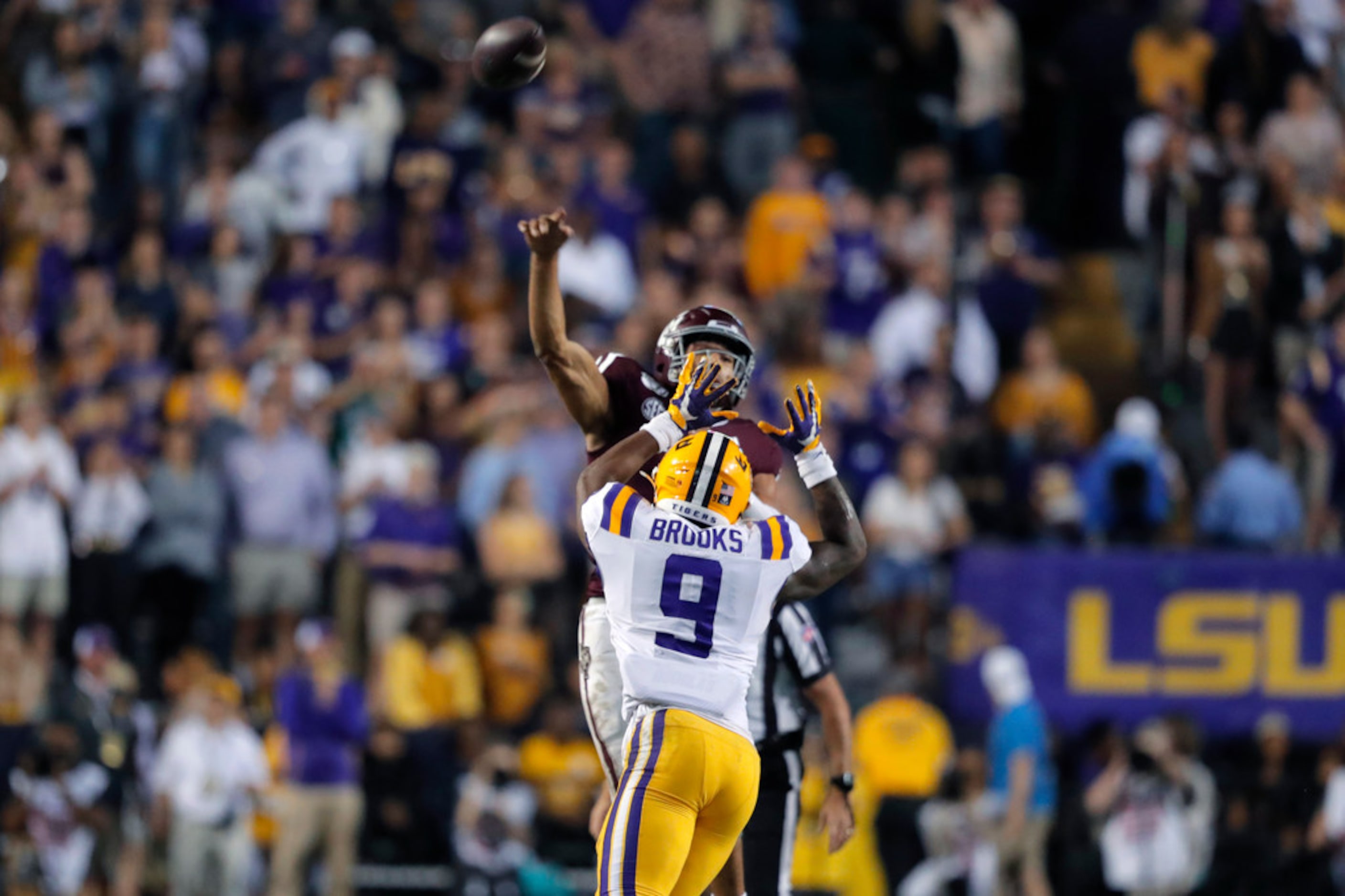 Texas A&M quarterback Kellen Mond throws an interception under pressure from LSU safety...