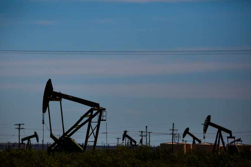 Oil pumpjacks line the horizon just west of Penwell, Texas, in the Permian basin.