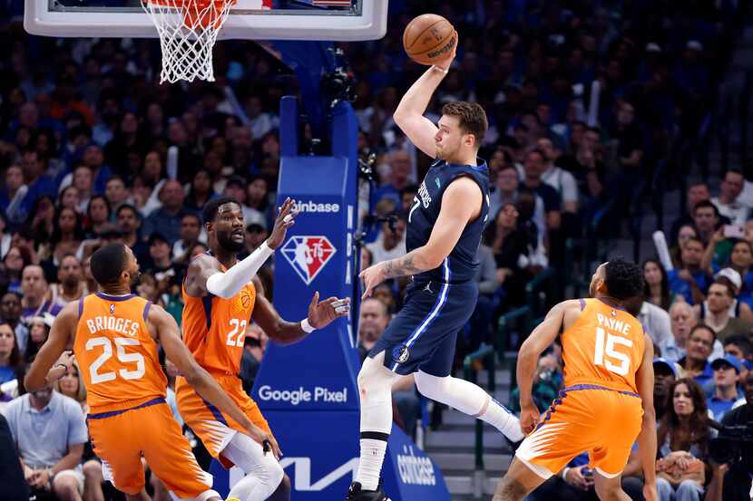 Dallas Mavericks guard Luka Doncic (77) passes the ball as he entered the lane against the...