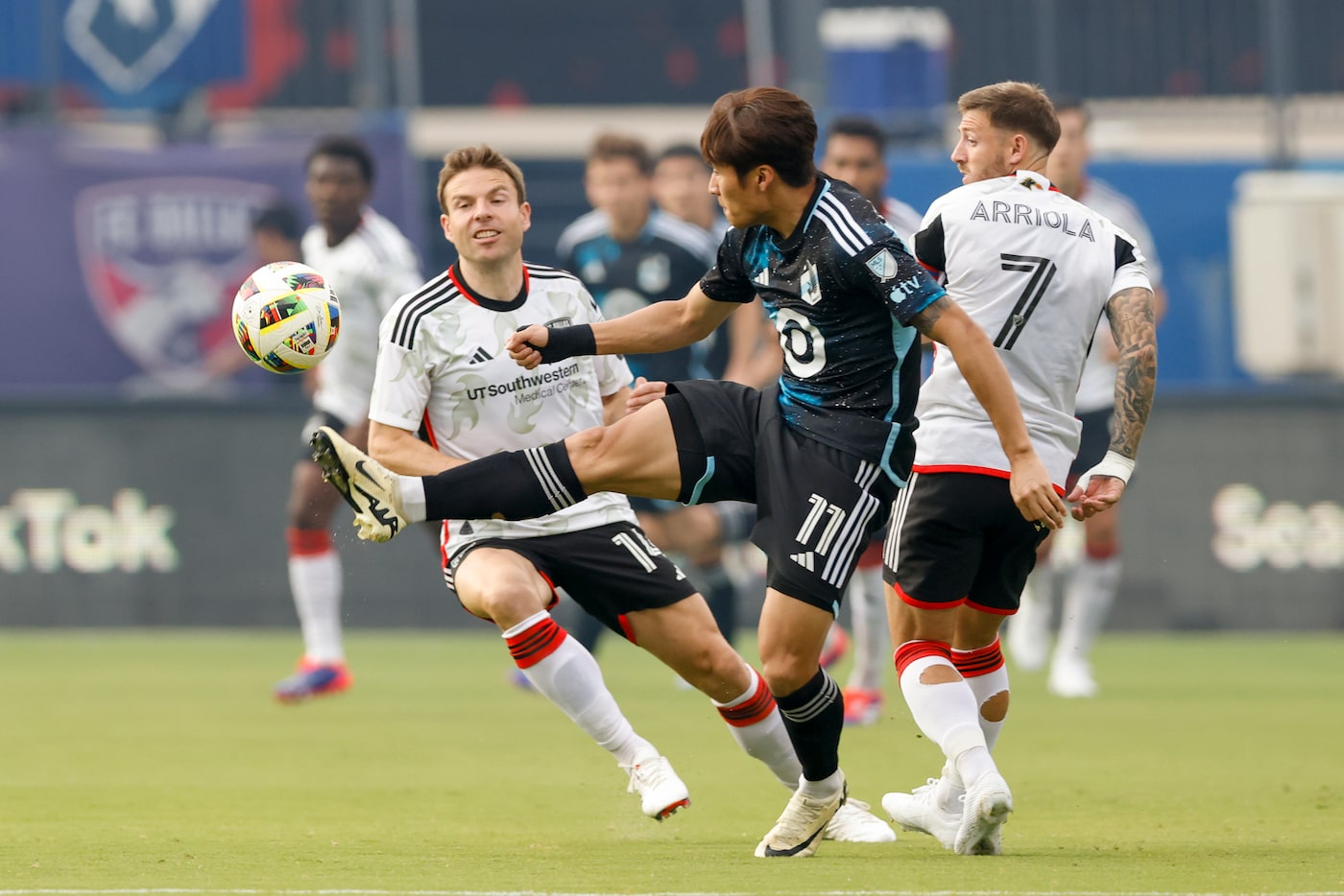 Minnesota United forward Jeong Sang-Bin (11) handles the ball ahead of FC Dallas midfielder...