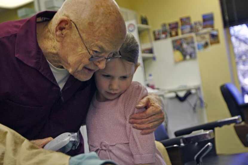 
Will Williamson embraced his great-granddaughter at his retirement celebration.


