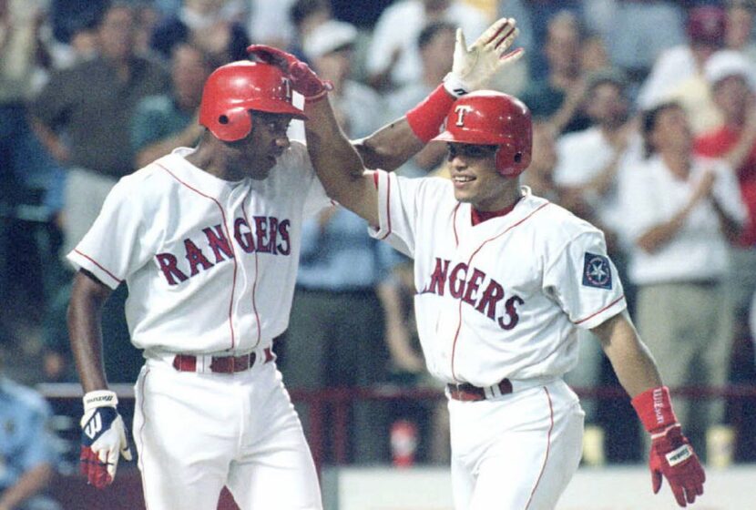 ARLINGTON, UNITED STATES:  Ivan"Pudge"Rodriguez of the Texas Rangers (R) is congratulated...