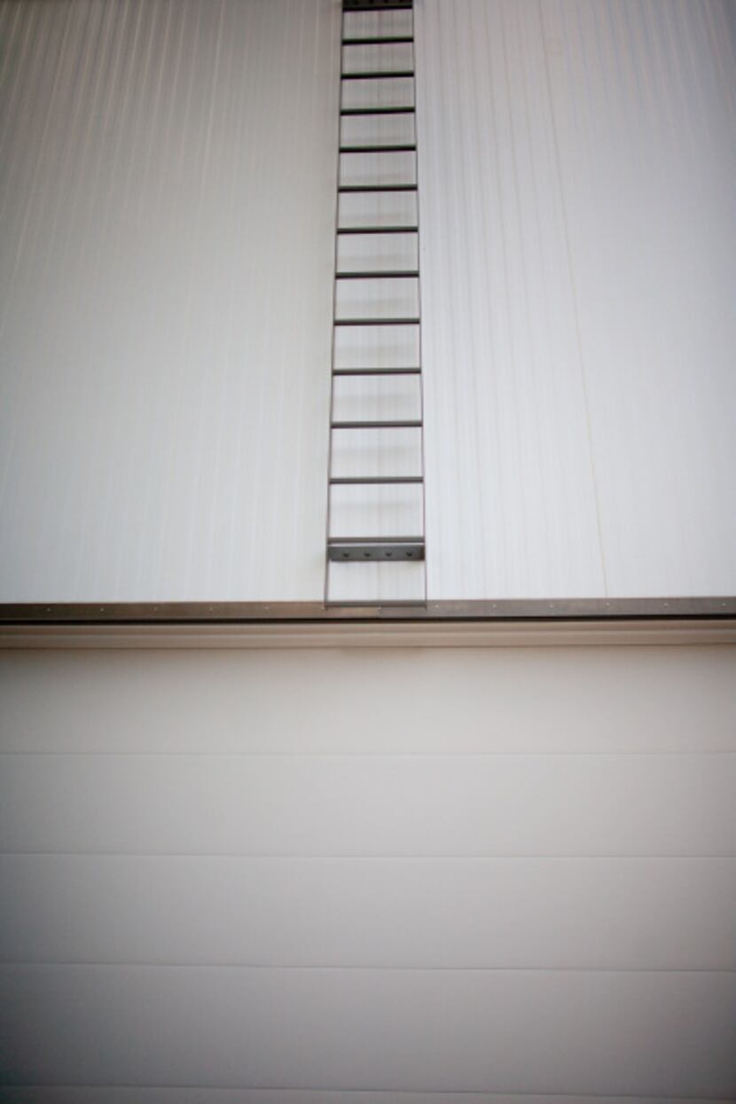 A minimalist ladder above the garage offers roof access