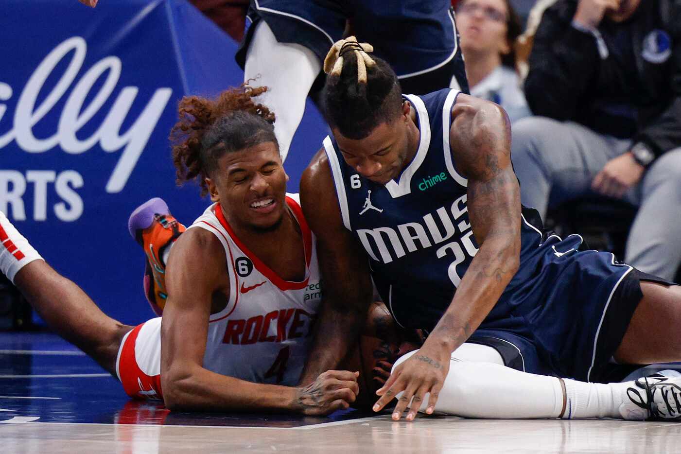 Dallas Mavericks forward Reggie Bullock (25) battles for a loose ball with Houston Rockets...