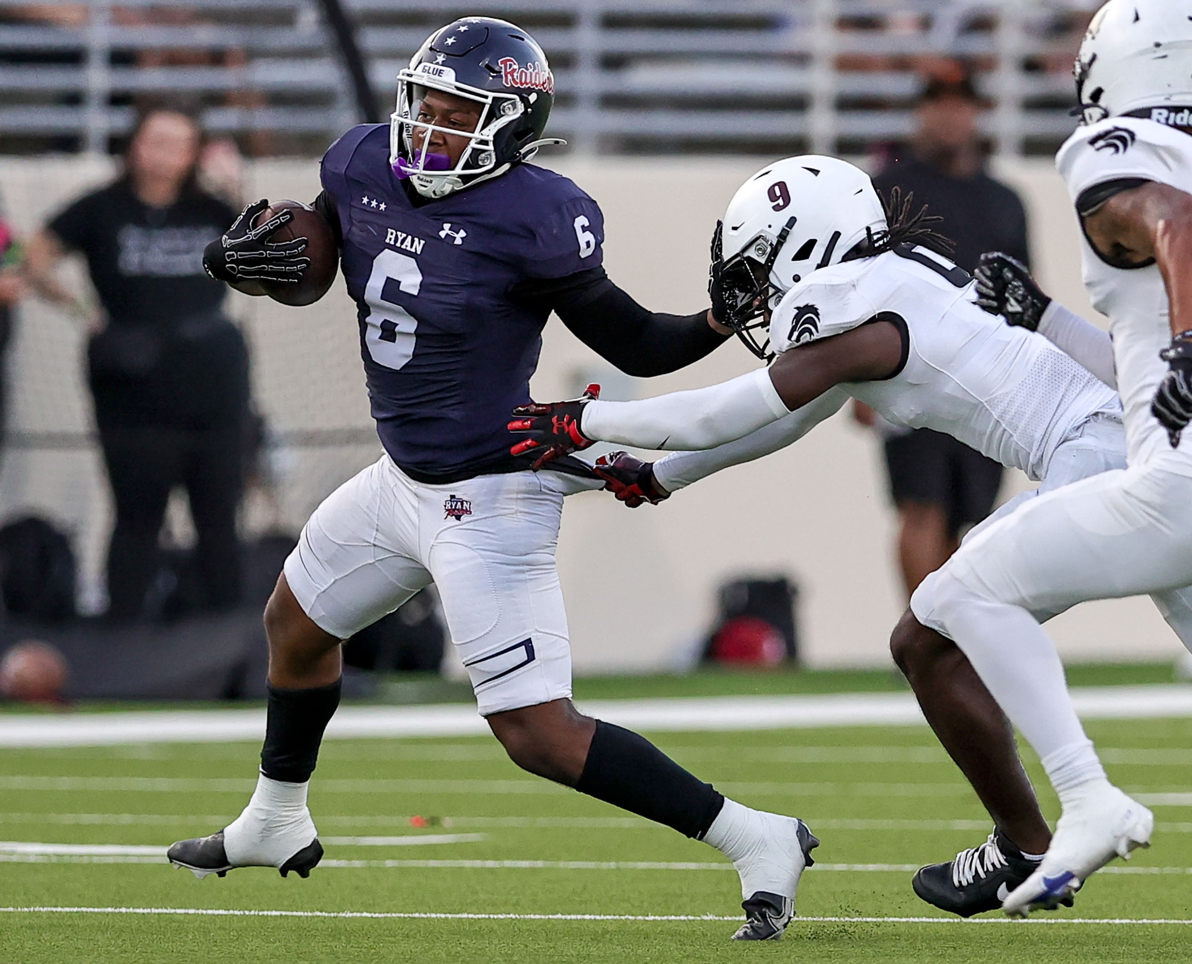 Denton Ryan running back Nemo Warmate (6) tries to get the past Mansfield Timberview safety...