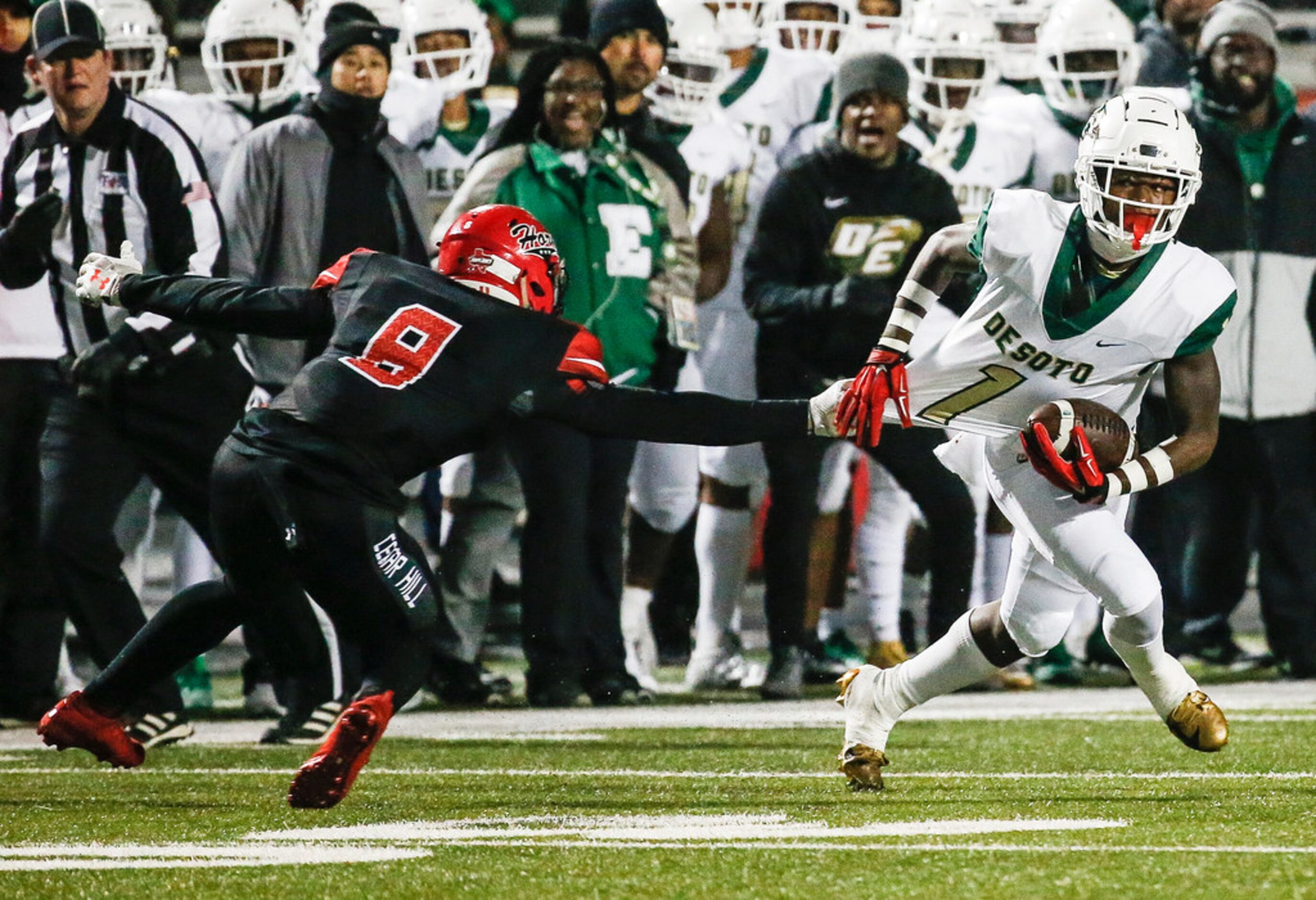 DeSoto wide receiver Jordan Brown works to break free from Cedar Hill linebacker Stefan...