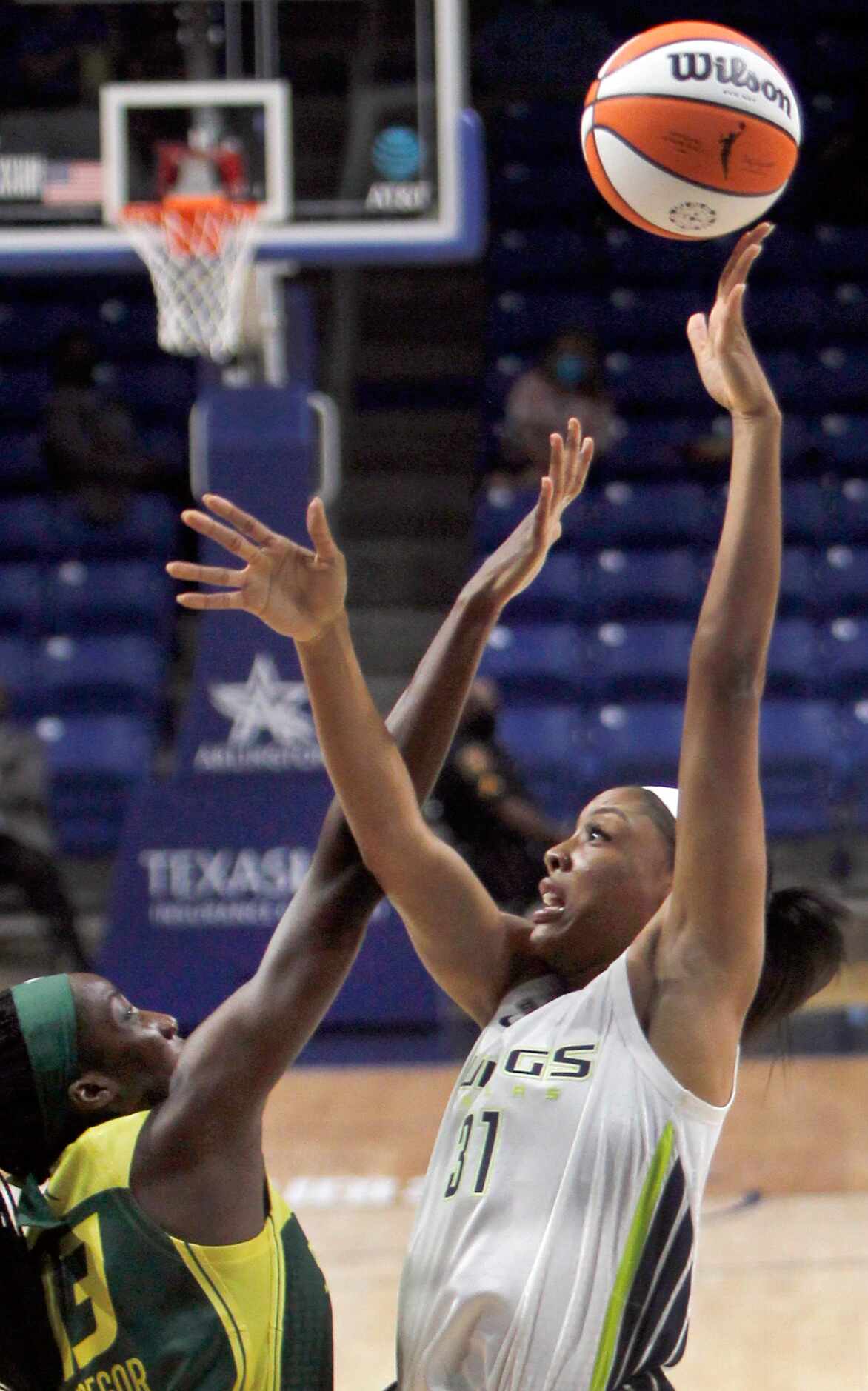Dallas Wings center Kristine Anigwe (31) puts a soft touch on a shot over Seattle center Ezi...