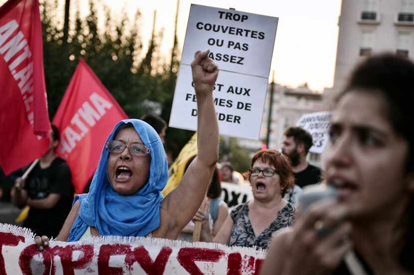 A woman shouts as anti-racism activists march towards the French embassy in Athens on August...