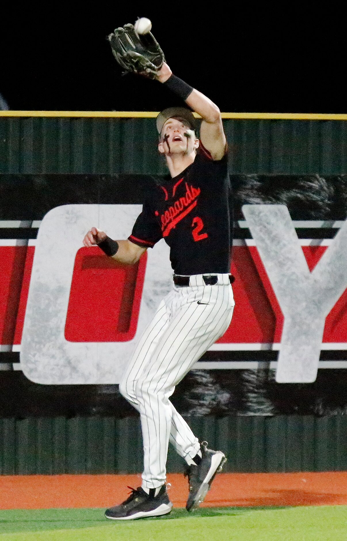 Lovejoy High School left fielder Trent Rucker (2) catches a fly ball for an out in the third...