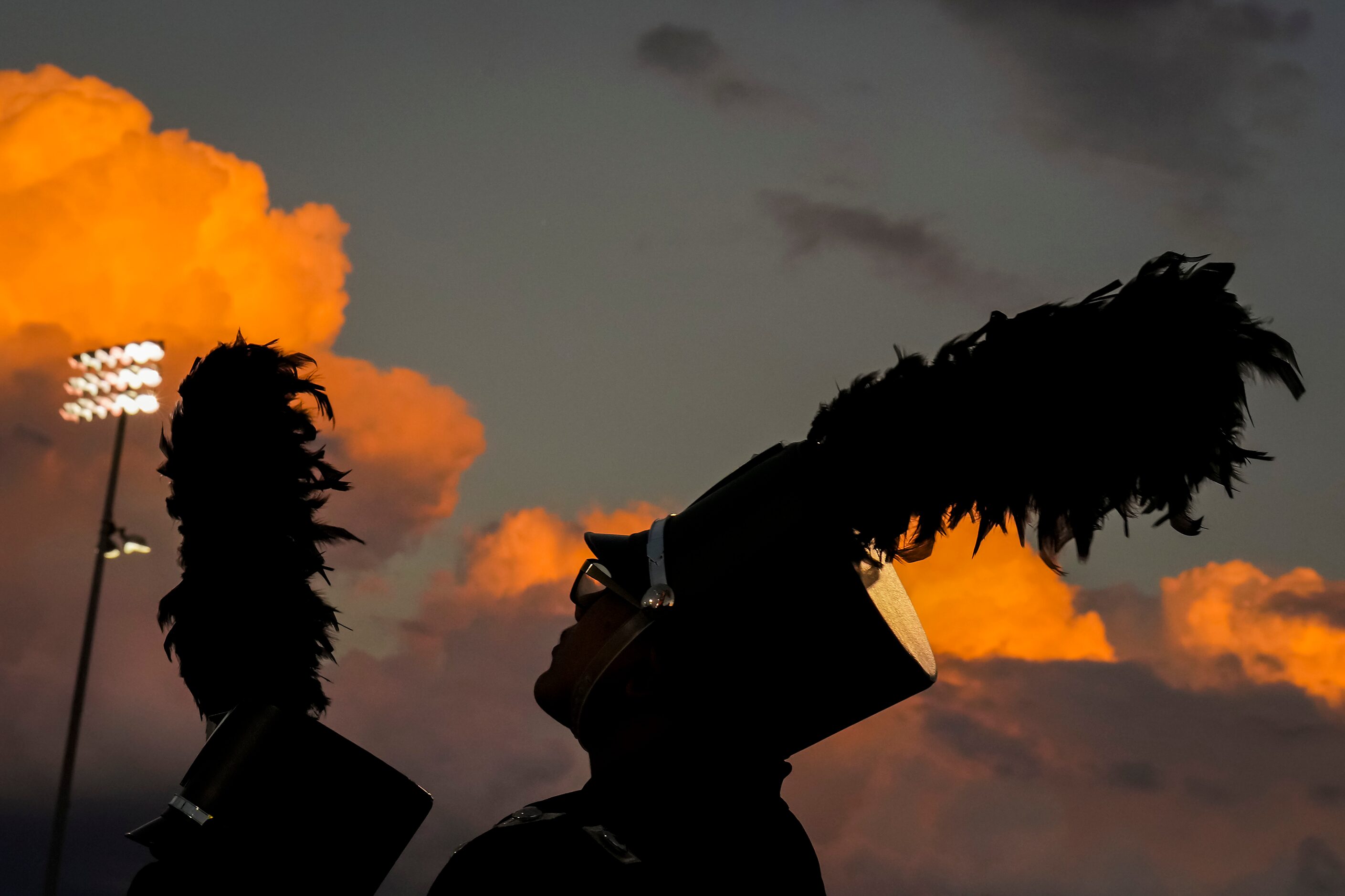 Members of the Prosper marching band wait to perform at halftime of a season-opening high...