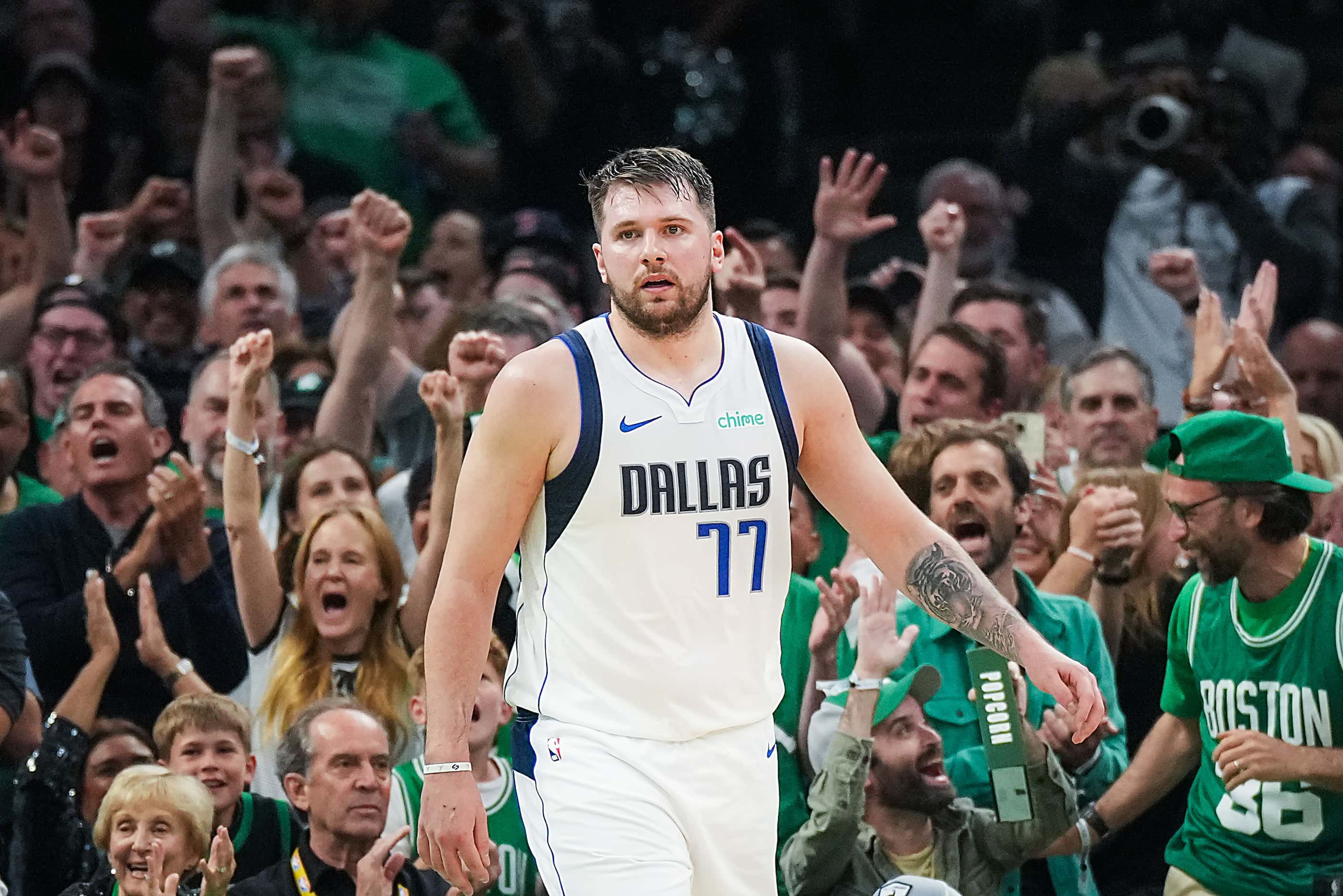 Dallas Mavericks guard Luka Doncic (77) reacts after a Boston Celtics 3-pointer during the...