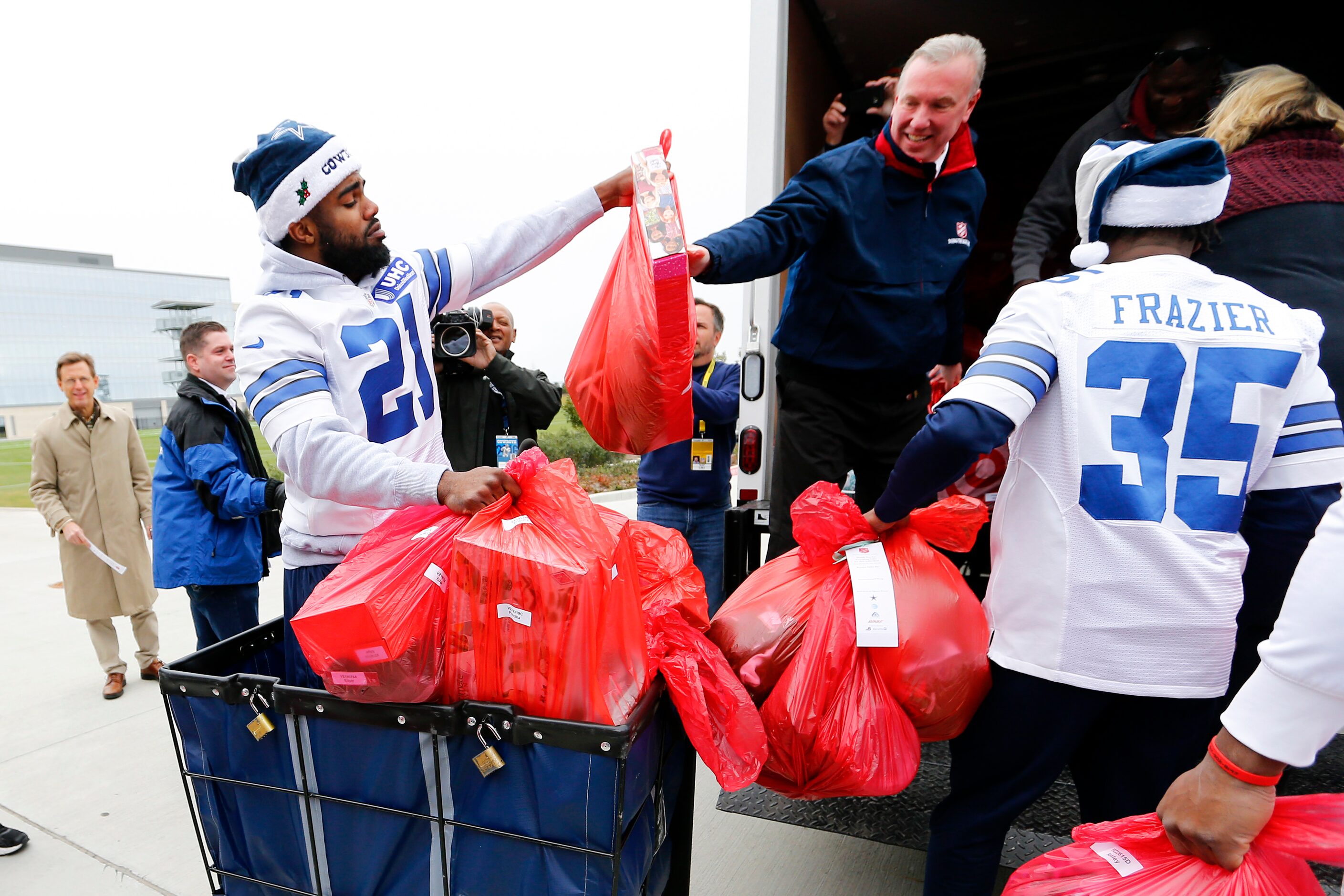 Dallas Cowboys running back Ezekiel Elliott (21) received a ride in a gift carrier as he...