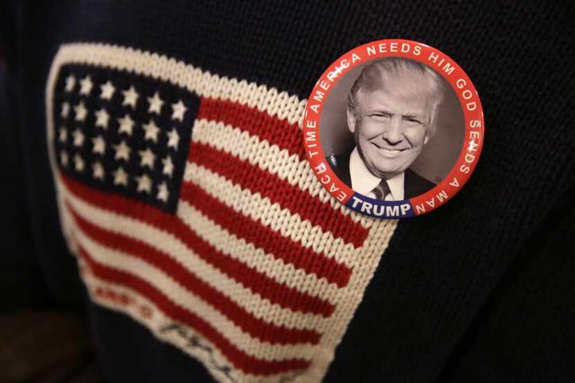 
A supporter wears a button promoting Republican presidential candidate Donald Trump.
