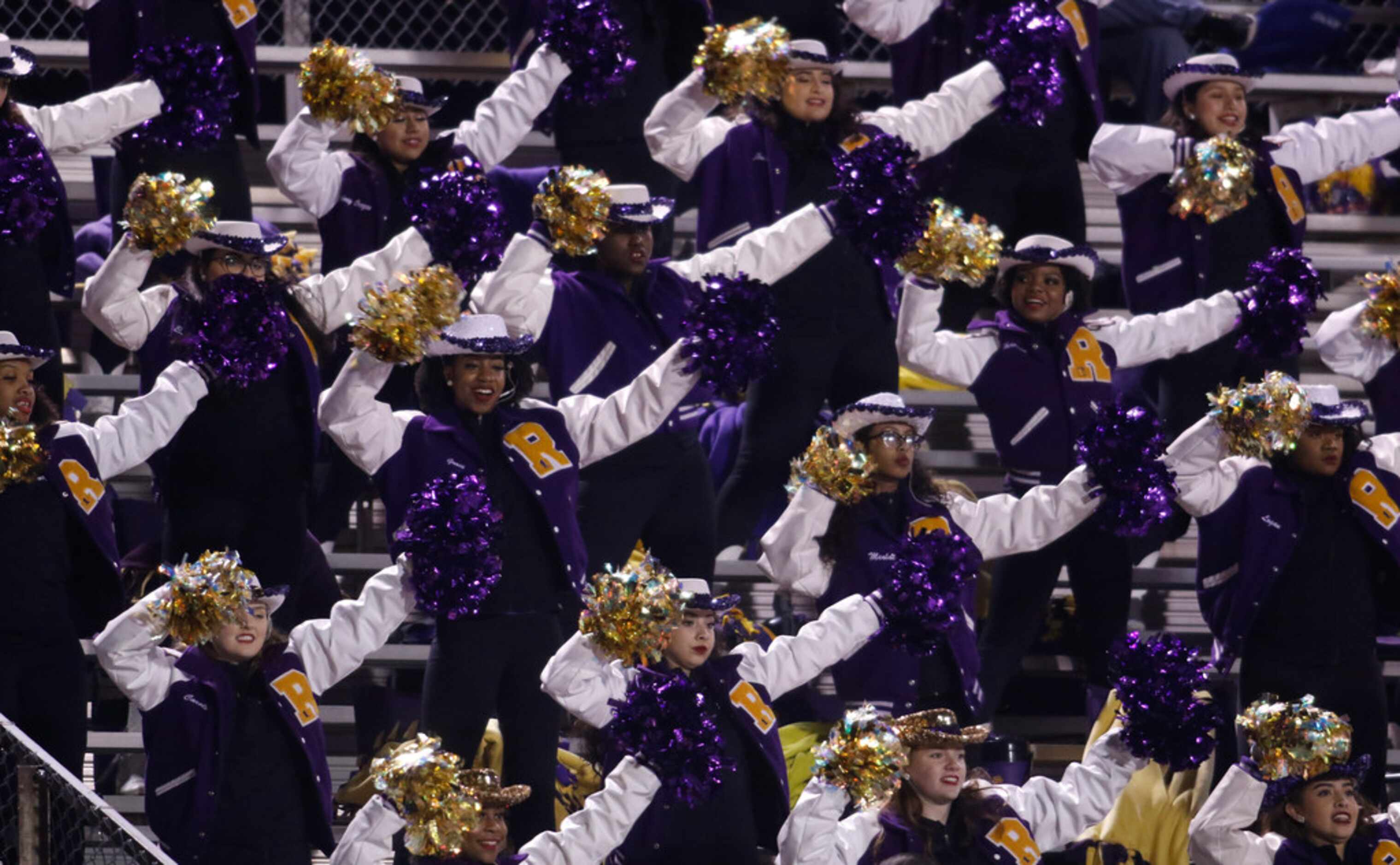 Members of the Richardson Drill Team perform in the stands during the first quarter of their...