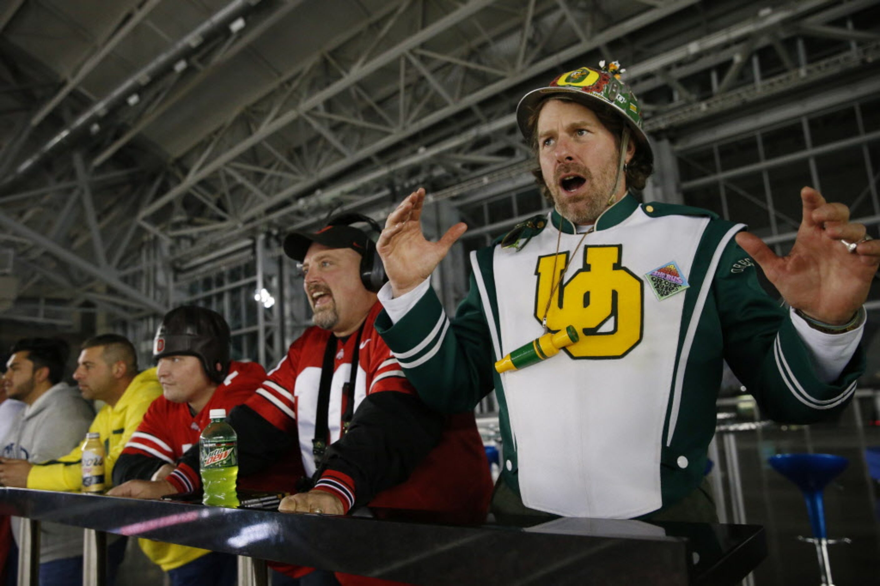 Oregon Ducks fan Warner Munro (right), of Portland, Oregon, reacts to a play in the first...