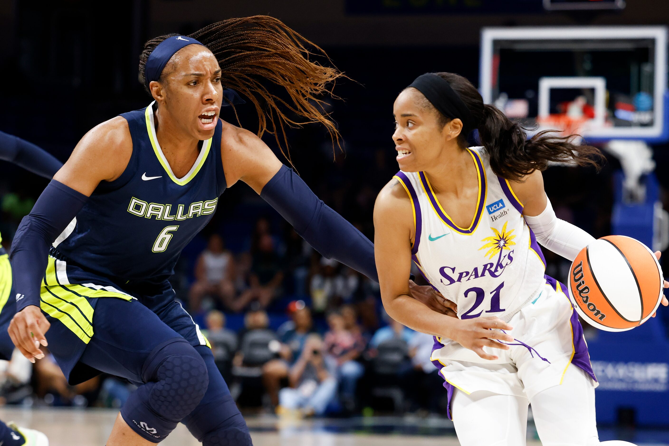 Los Angeles Sparks guard Jordin Canada (21) dribbles past Dallas Wings forward Kayla...