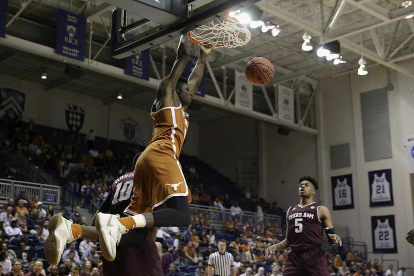 Texas forward Mohamed Bamba (4) dunks the ball defended by Texas A&M center Tonny...