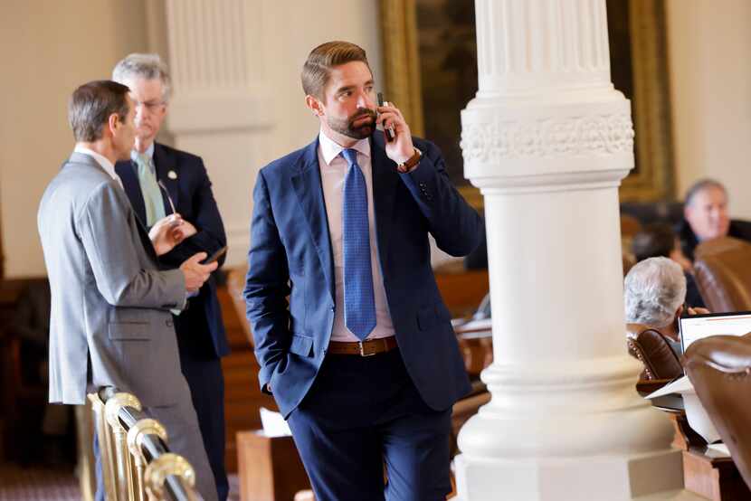 State Rep. Jeff Leach, R-Allen, talks on the phone while on the floor of the House chamber...
