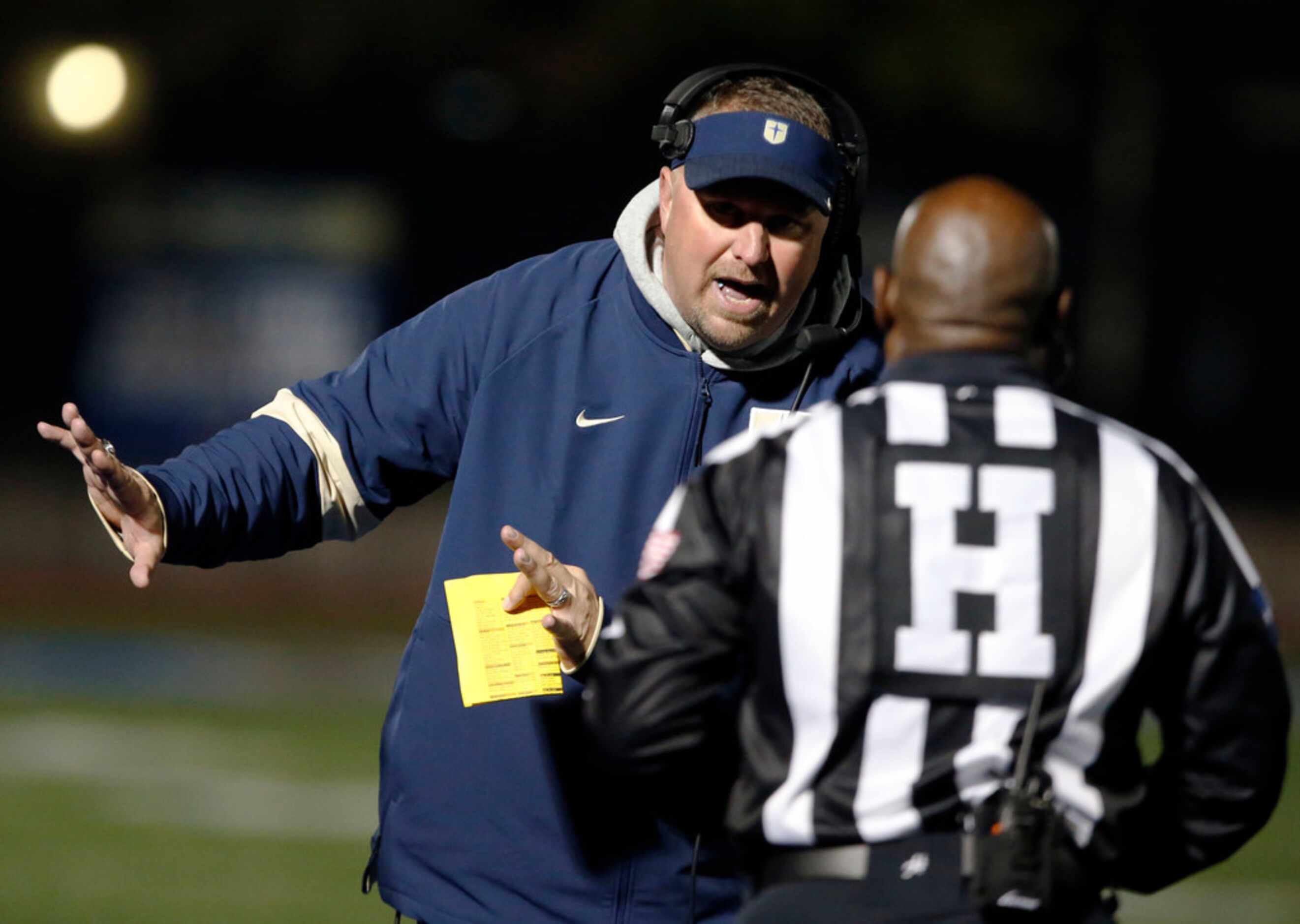 The Jesuit coach Brandon Hickman talks with a game official during the first half of the...