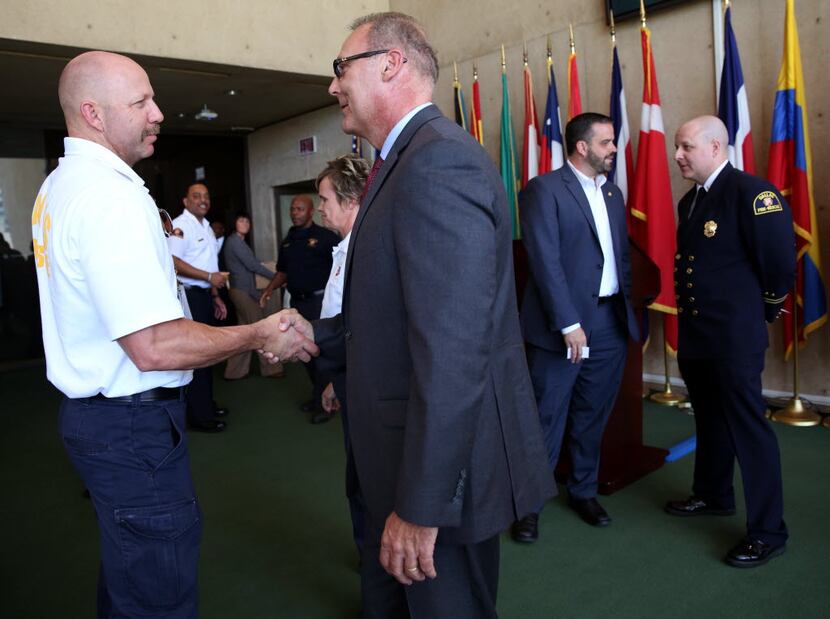 New Dallas Fire Chief David Coatney (right) shook hands with Battalion Chief Cameron Creager...