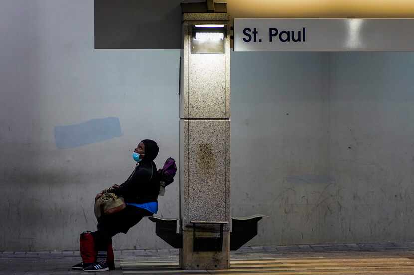 A passenger wearing a protective face mask waited for a train at the DART rail St. Paul...