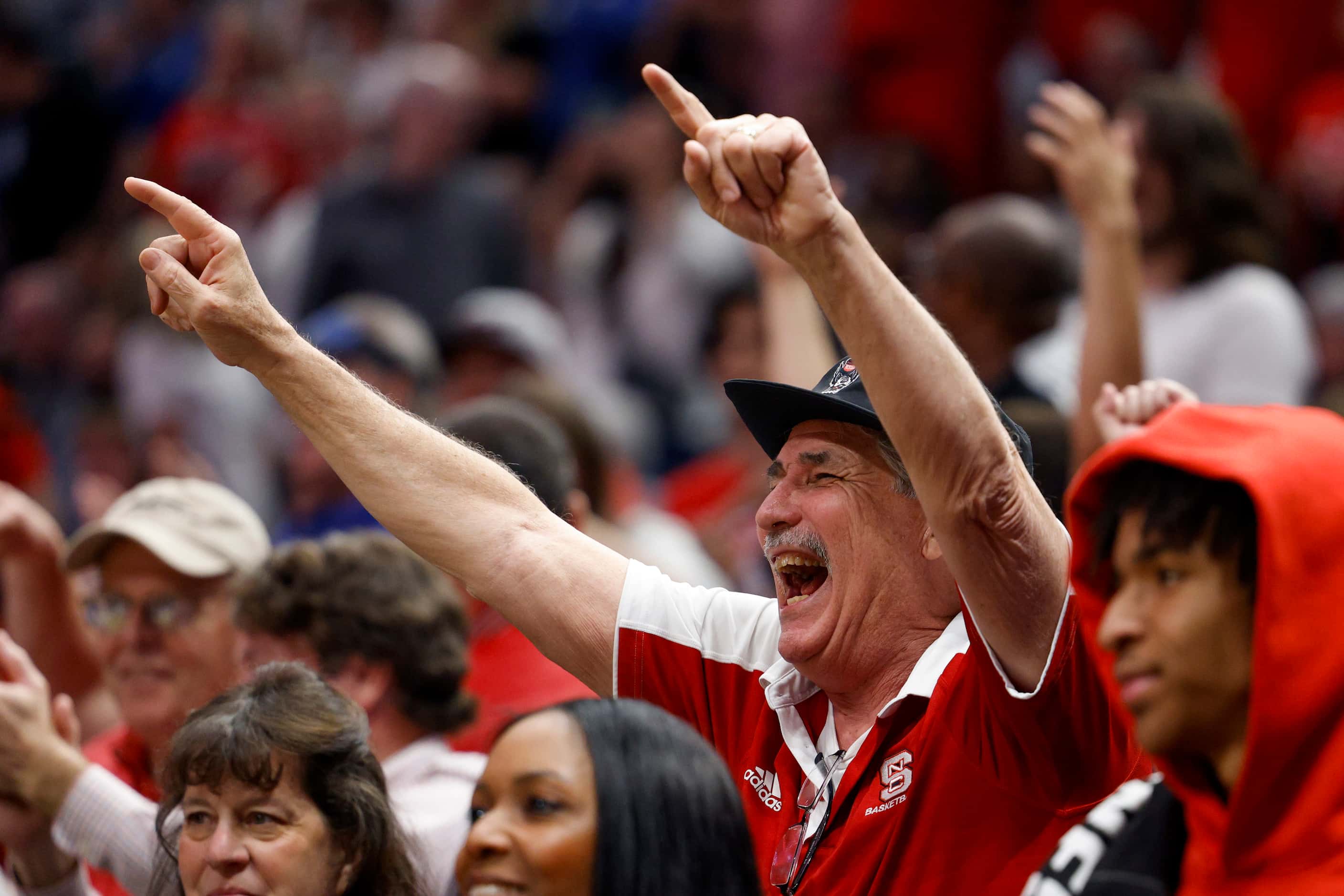 North Carolina State fans cheer in the closing seconds during the second half of an NCAA...