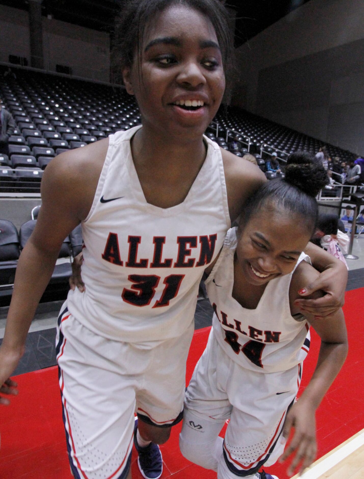 Allen senior guard Nyah Green (31) shares a hug with senior guard Cydni Adams (24) following...