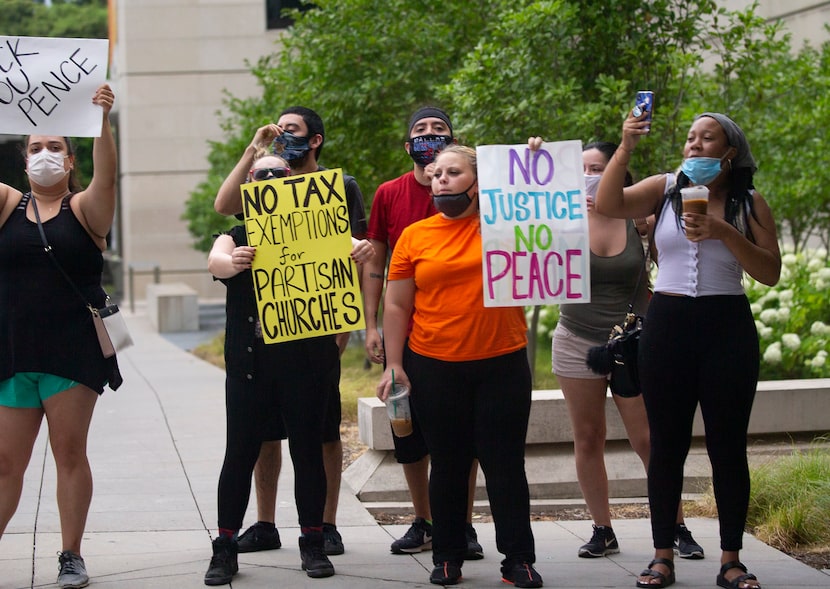 Protestors rally as Vice President Mike Pence makes his way to First Baptist Church on...