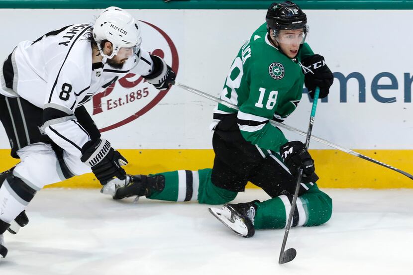 Dallas Stars center Tyler Pitlick (18) and Los Angeles Kings defenseman Drew Doughty (8)...