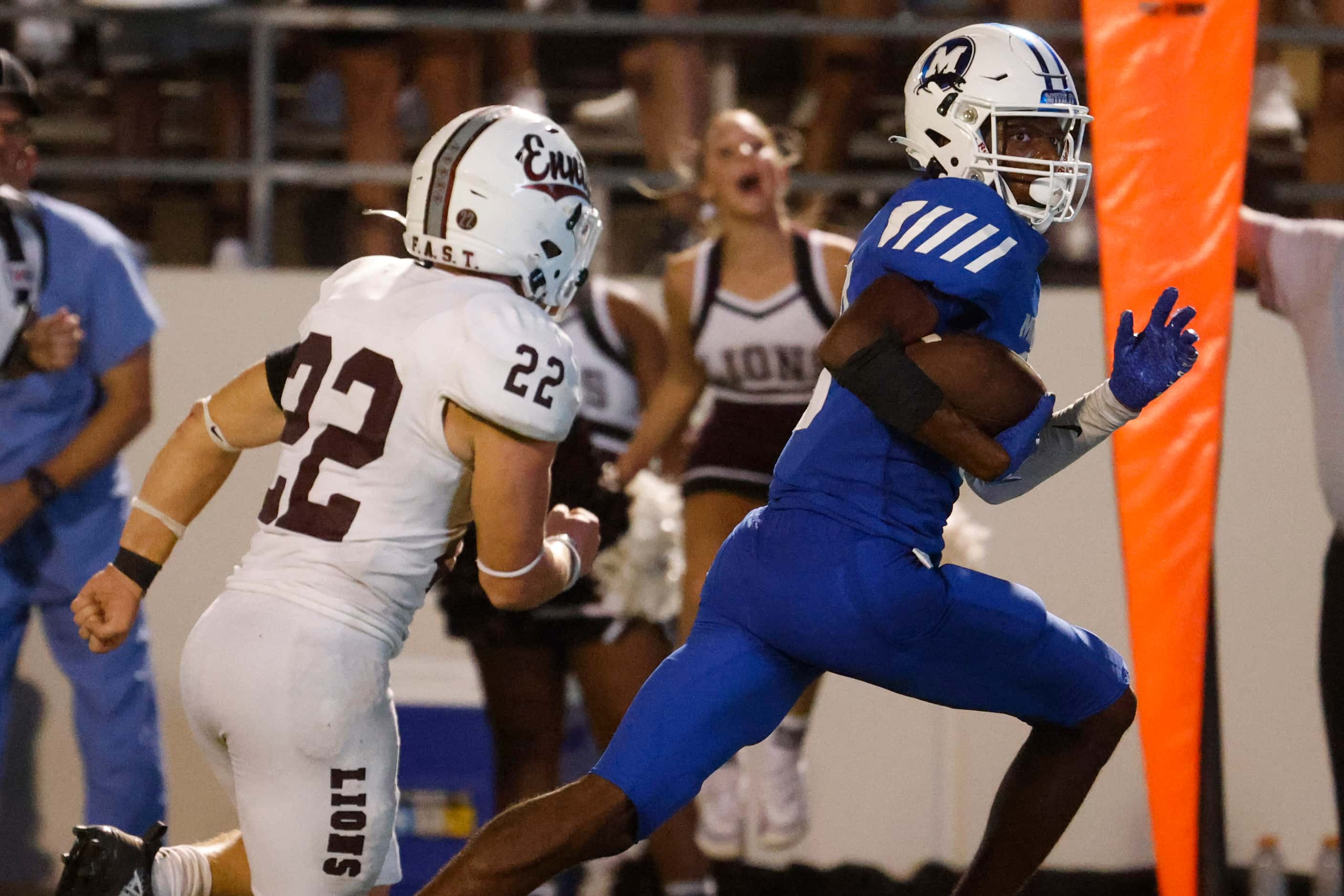 Midlothian High’s Bryant Wesco (right) carries for a touchdown past Ennis high school’s...