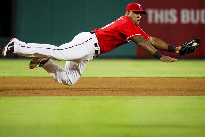 Texas Rangers third baseman Adrian Beltre makes a diving stop on a grounder by Pittsburgh...