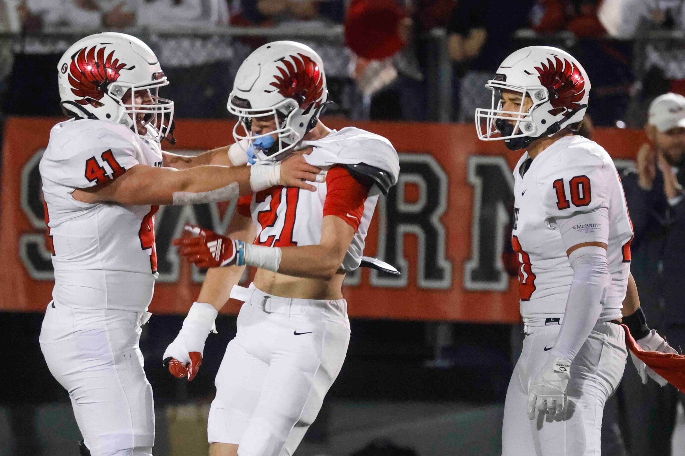 Argyle High’s Hunter Sandifer (41), left, Trey Batson (21), center, and Grant Mirabal (10),...