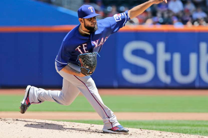 Texas Rangers starting pitcher Martin Perez throws during the first inning of a baseball...