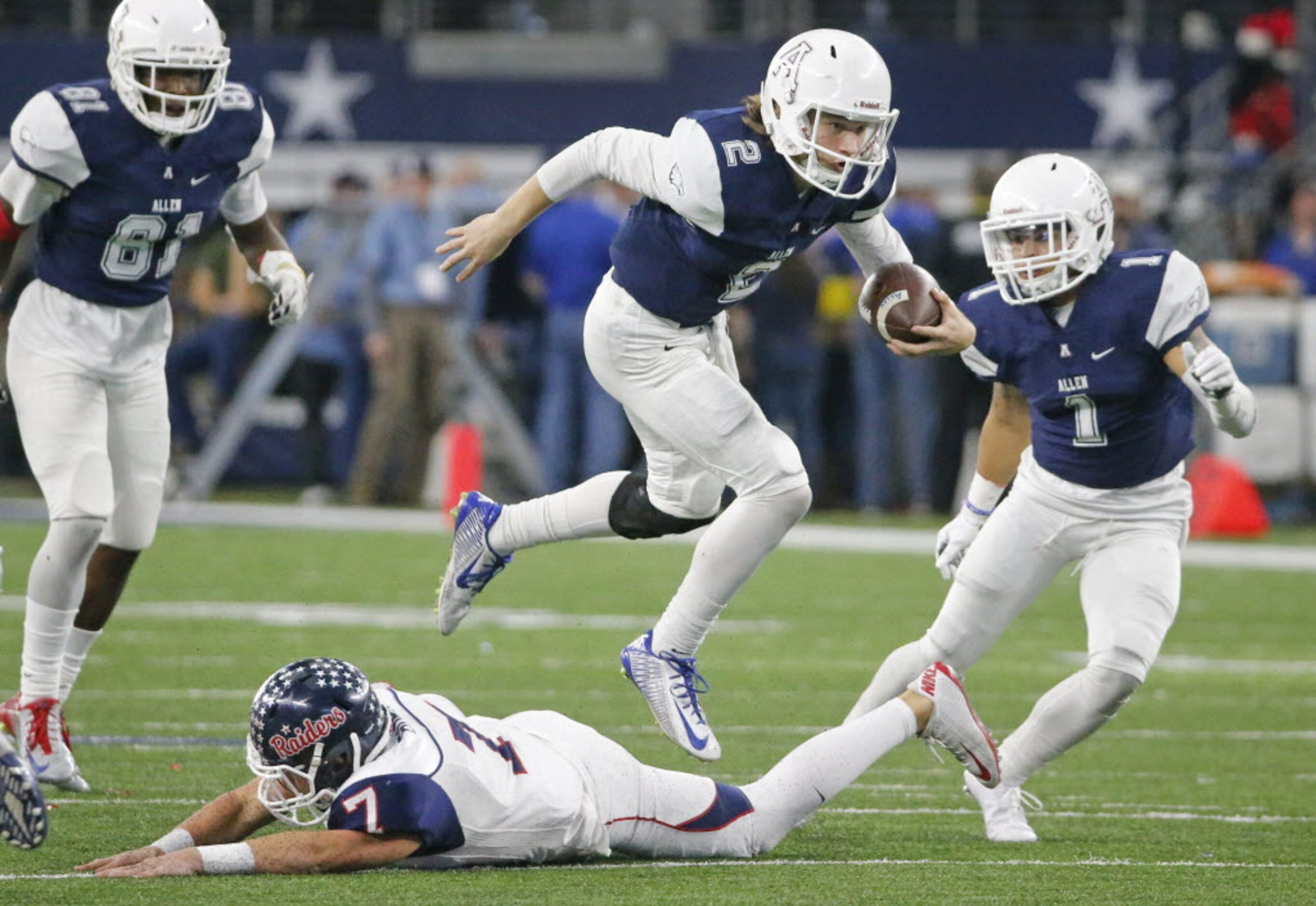 Allen quarterback Mitchell Jonke (2) leaps over Ryan defender  Toby Burch (7) on his way to...