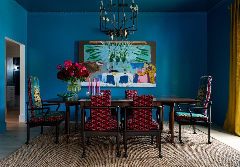 A neutral rug from West Elm balances out the strong use of color in this dining room.