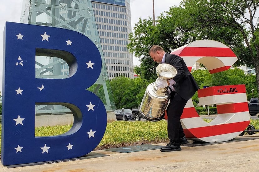 Howie Borrow, Keeper of the Stanley Cup, approaches a "B-(i)-G" sign near the Omni Hotel in...