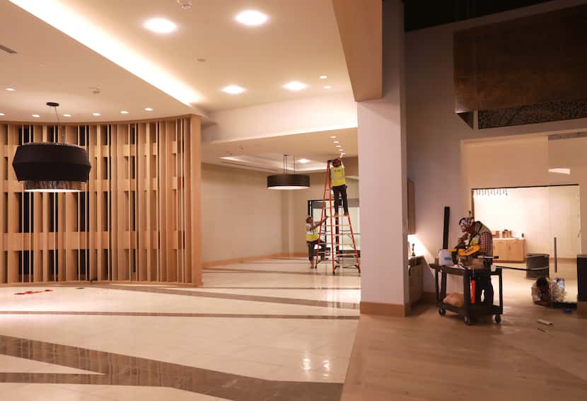 Workers put the finishing touches on the lobby and dining area of the Frisco Hyatt Regency.
