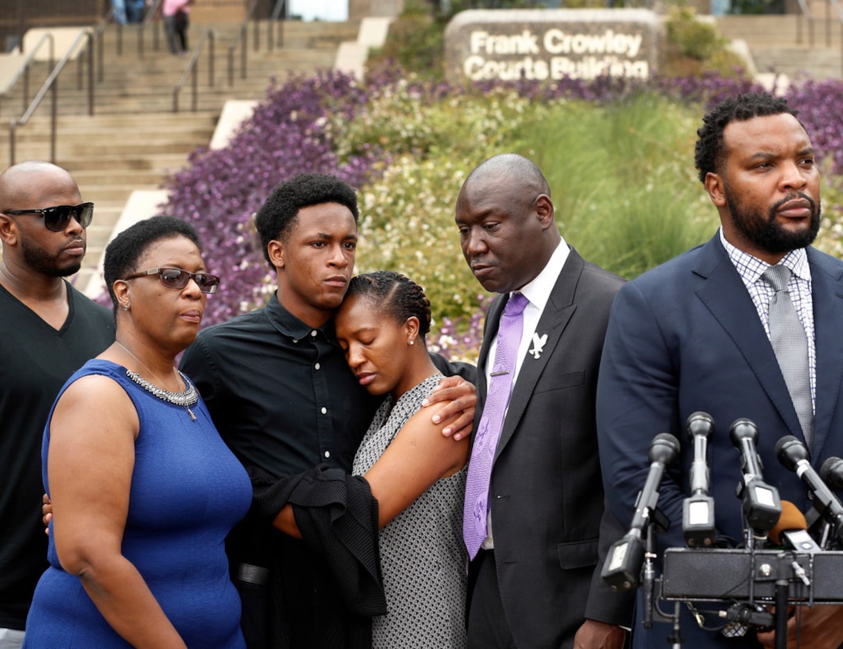 Brandt Jean, brother of shooting victim Botham Jean (third from left), hugs his sister...