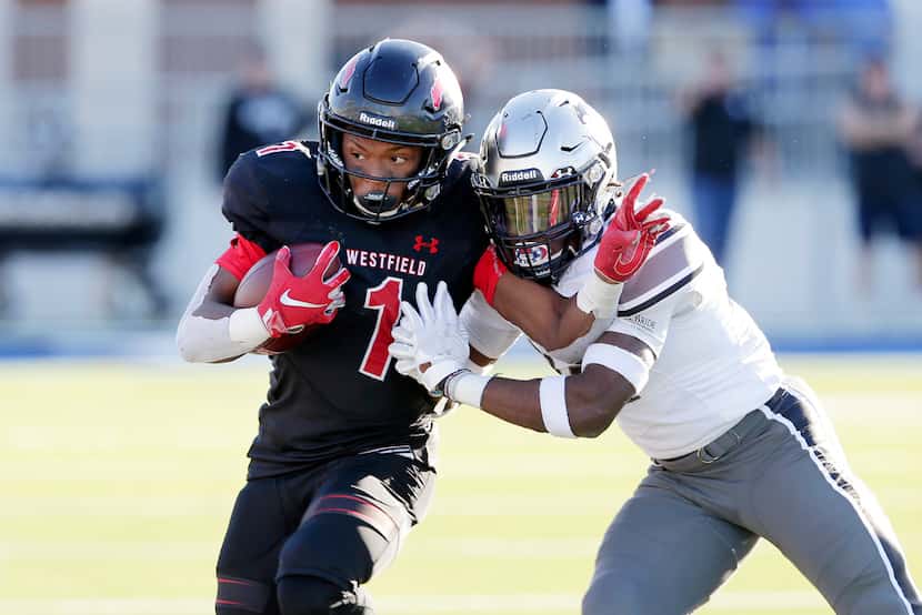 Spring Westfield running back Kendal Taylor (1) is pushed out of bounds by Guyer defensive...