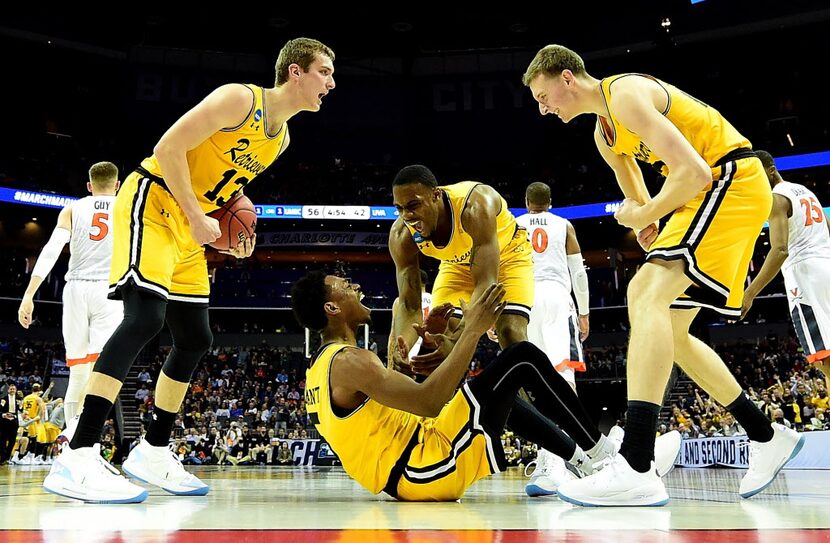 CHARLOTTE, NC - MARCH 16:  Jourdan Grant #5 and teammate Arkel Lamar #33 of the UMBC...