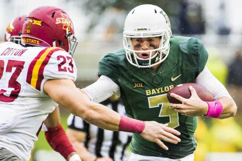 Baylor Bears quarterback Jarrett Stidham (3) fends off Iowa State Cyclones defensive back...