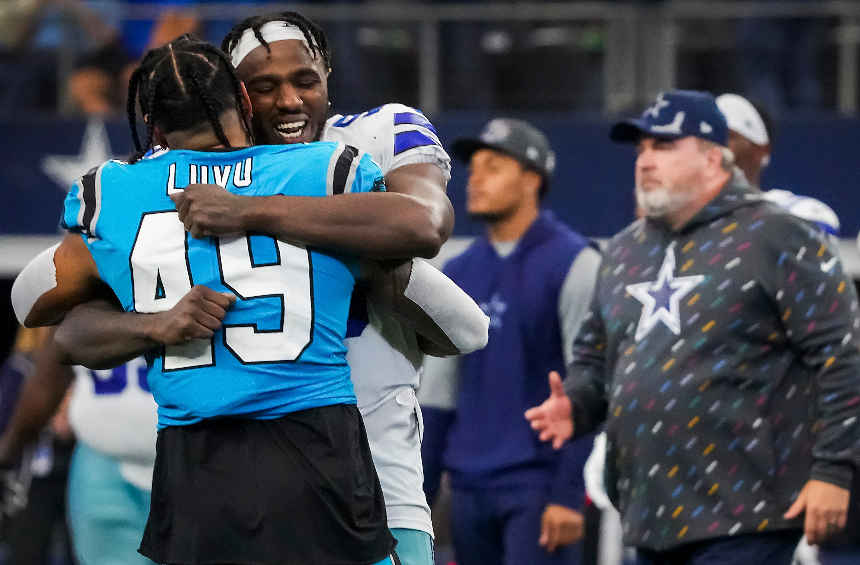 Dallas Cowboys defensive end Tarell Basham (93) hugs Carolina Panthers linebacker Frankie...