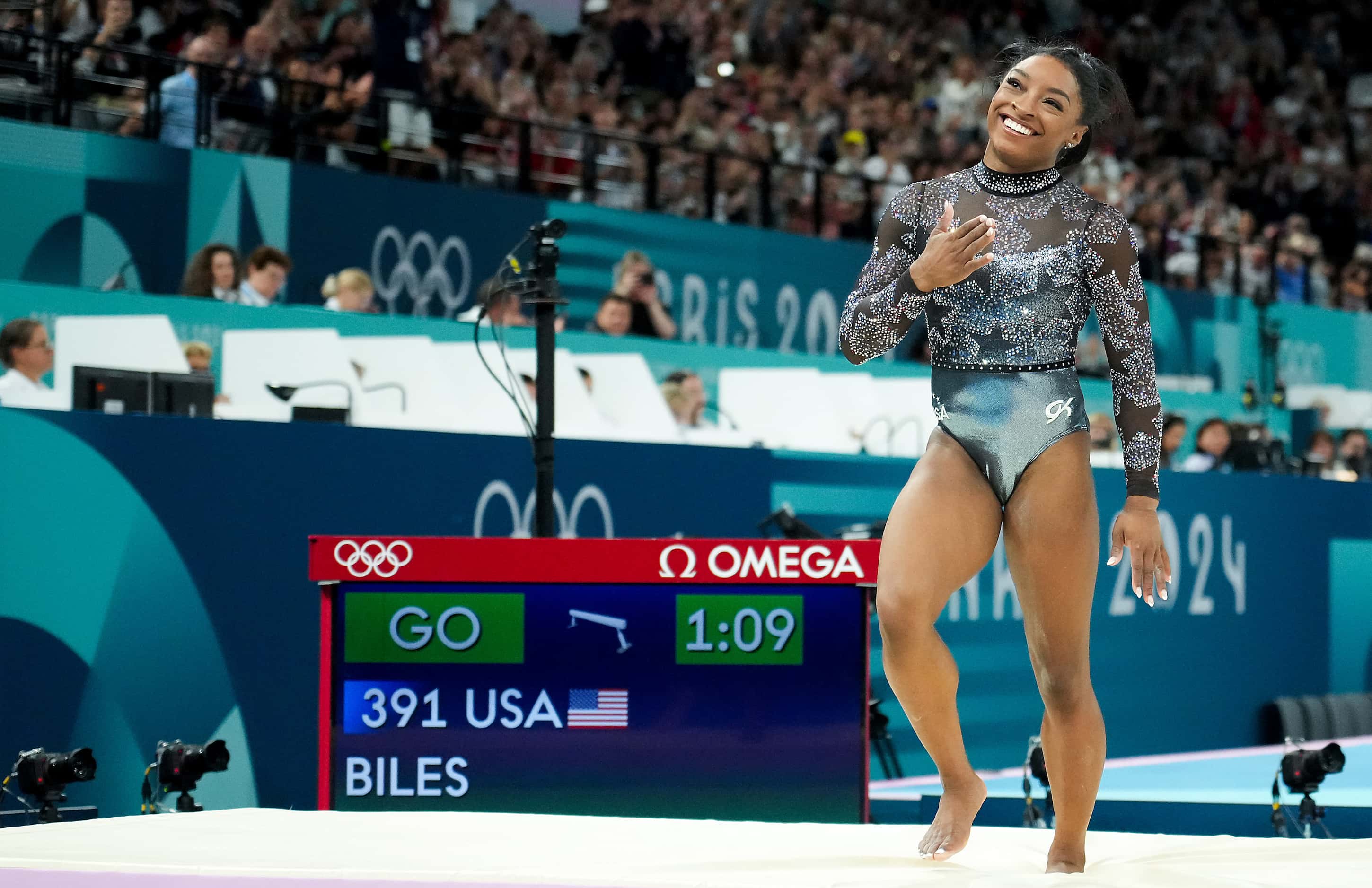 Simone Biles of the United States reacts to the crowd after she cometed on the balance beam...
