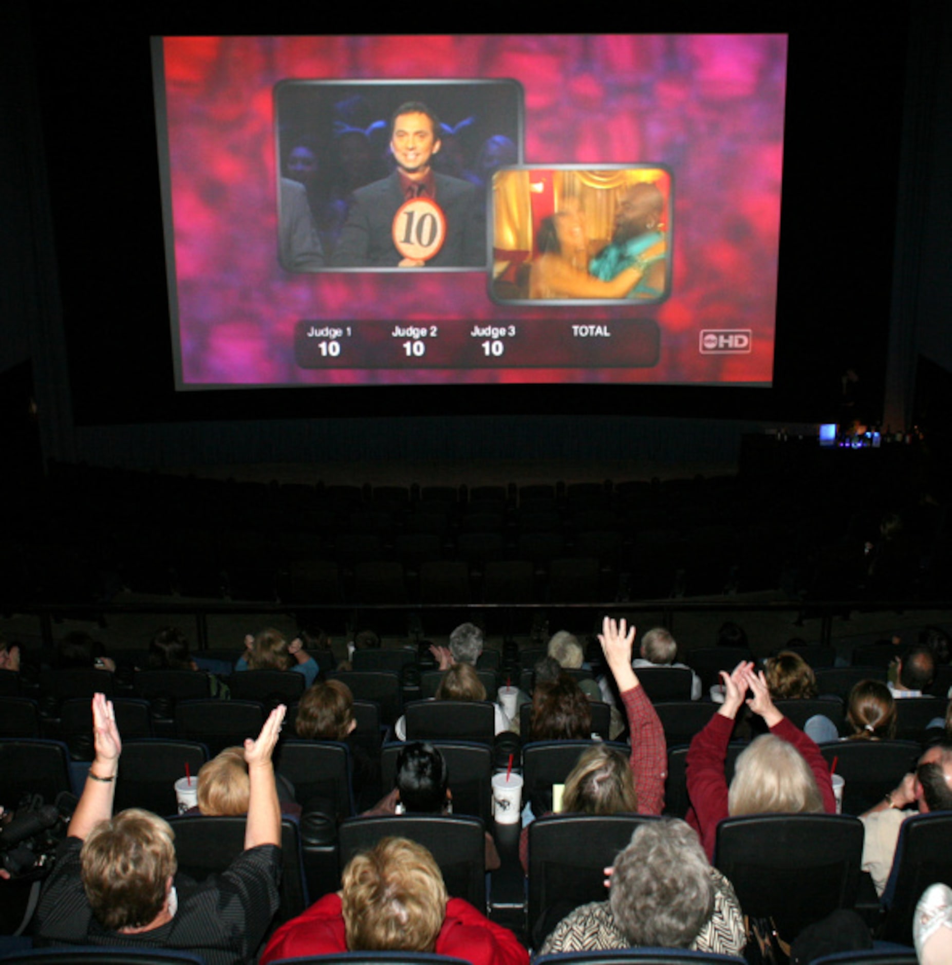 Fans at the Angelica Film Center in Dallas watch "Dancing With The Stars" as Emmitt Smith...