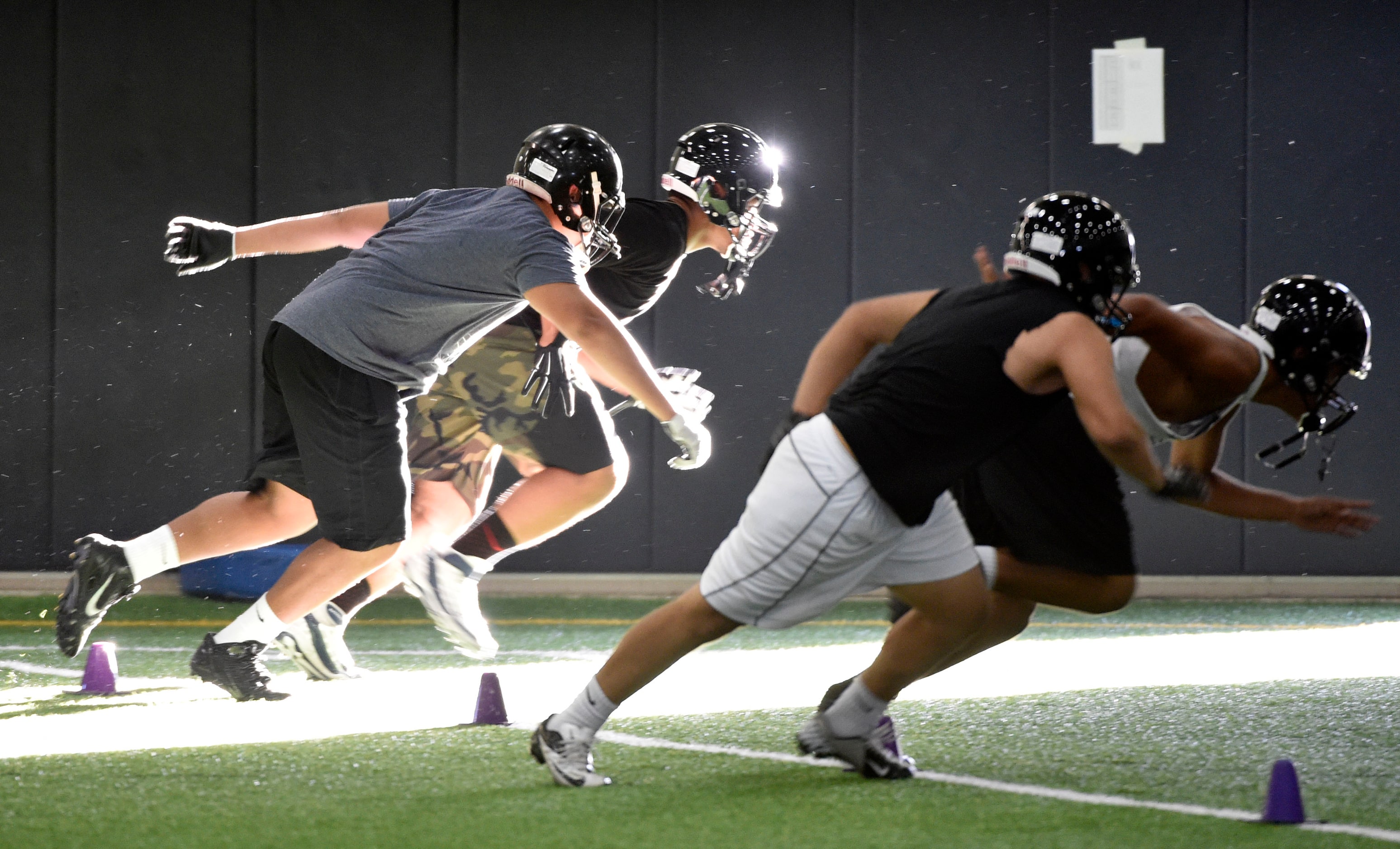 Players work on their footworks during Euless Trinity's first day of football practice at...