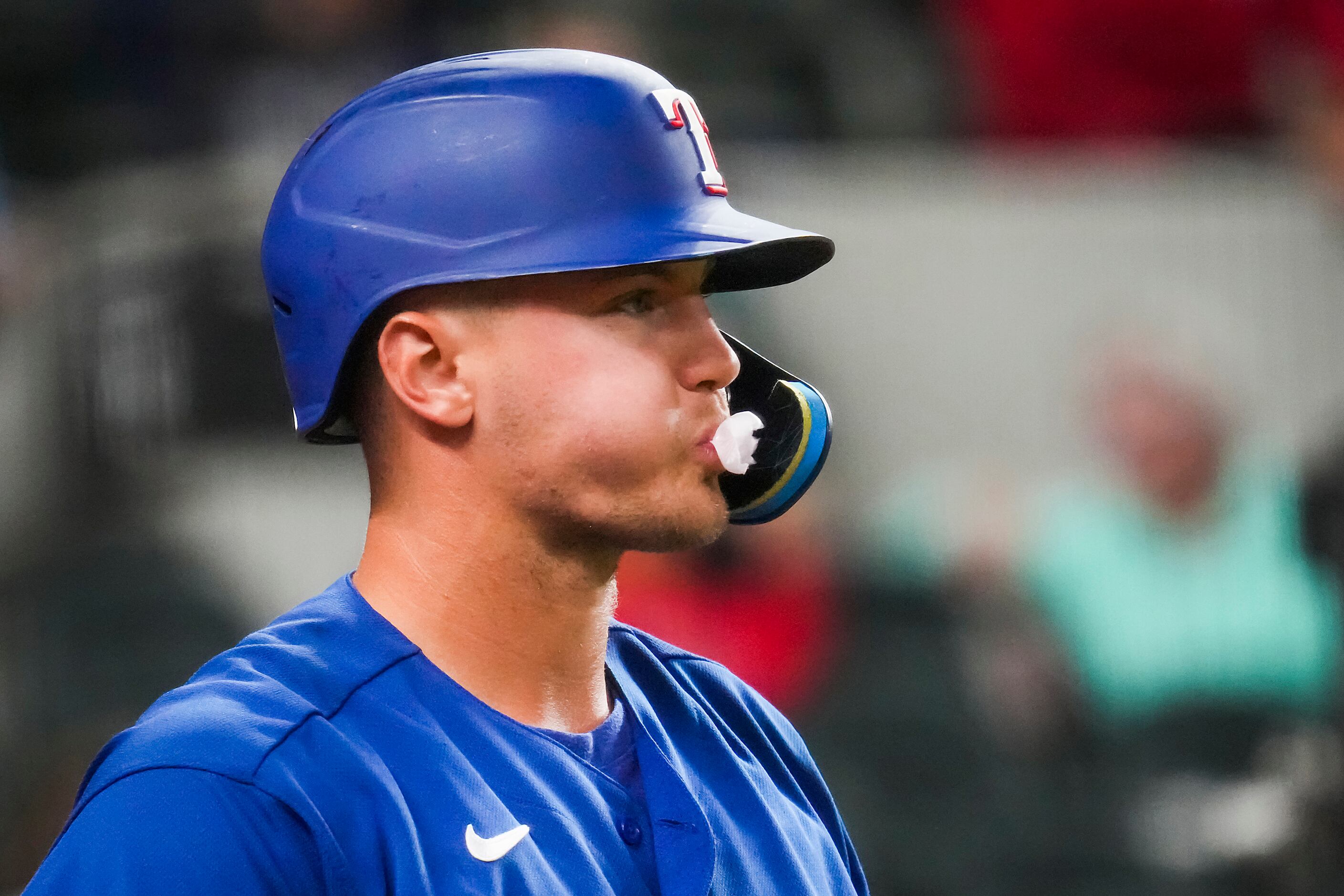 Texas Rangers third baseman Josh Jung blows a bubble in the on deck circle during the fourth...