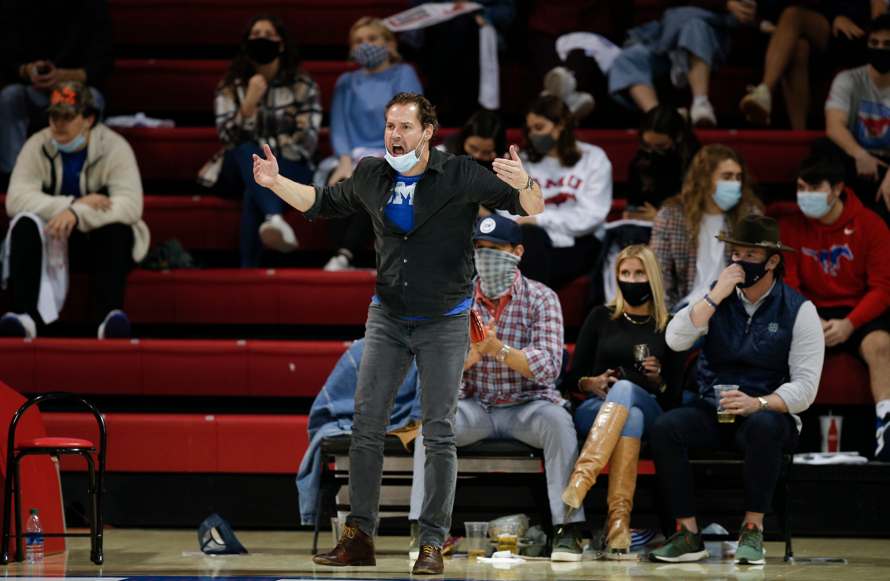 An SMU fan cheers on the team during the second half of a college basketball game against...